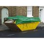 Green tarpaulin in use to cover a skip