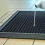 Disinfectant mat with flexible scrapers