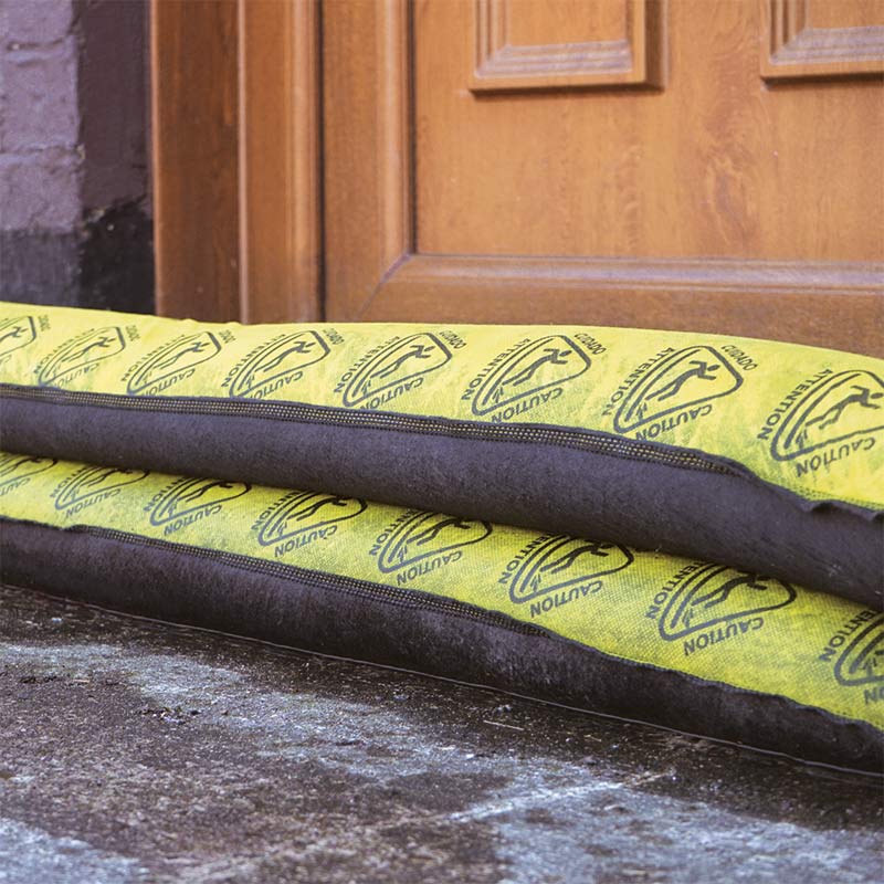 Inflatable absorbent barriers stacked to protect door threshold from flood water