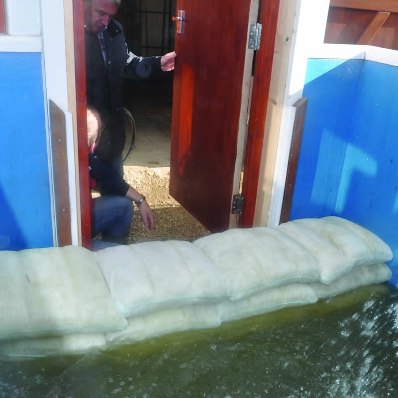 Expanding sandbags in a doorway