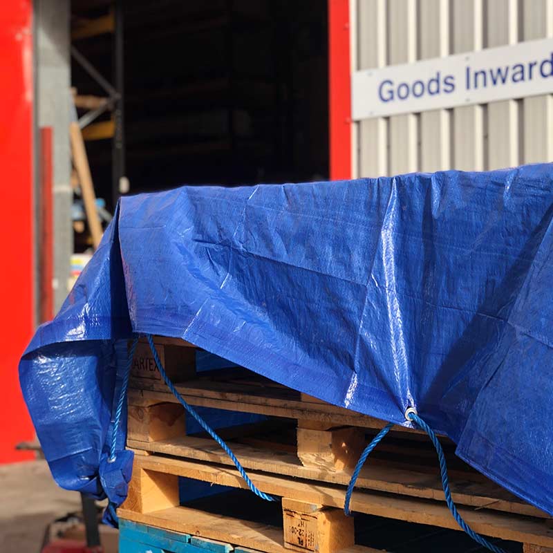 Prosolve blue tarpaulin with eyelets used to protect pallets