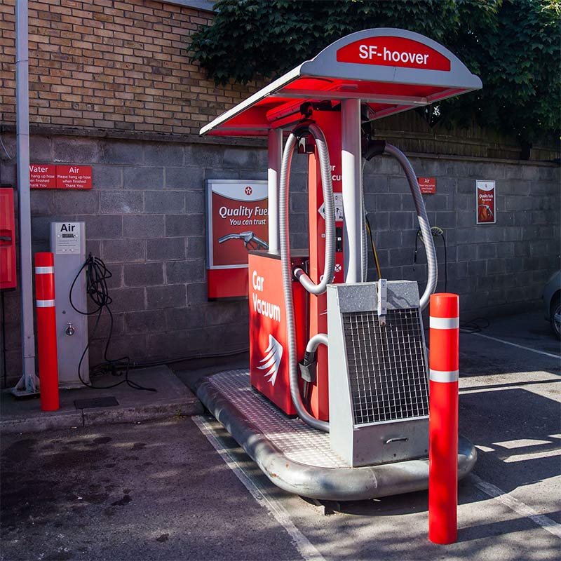 Red bollard sleeves with reflective strips at car vacuum